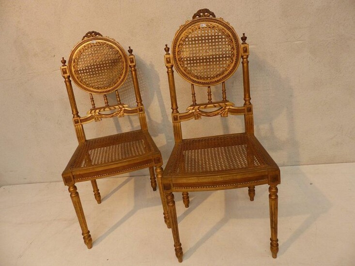 Pair of Louis XVI style chairs in gilded and carved wood.