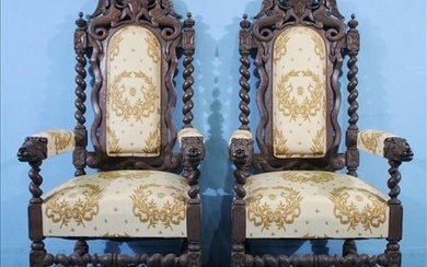 Pair of heavily carved oak fireside chairs with new upholstery