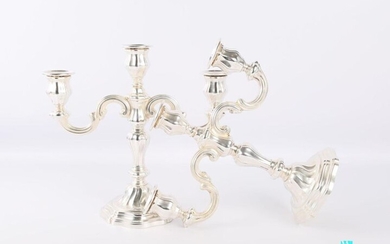 Pair of silver candelabra on a round base with a doucine decorated with fillets and topped with twists, the baluster shaft carries three lights, one of which is central.