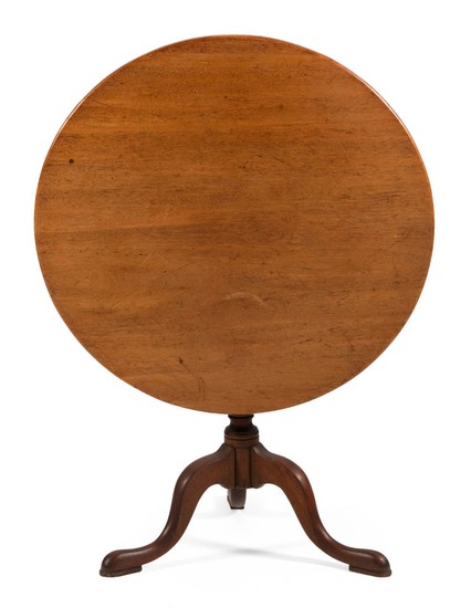 QUEEN ANNE TILT-TOP TABLE In mahogany, with round top, vasiform pedestal and cabriole legs ending in padded snake feet. Height 28"....
