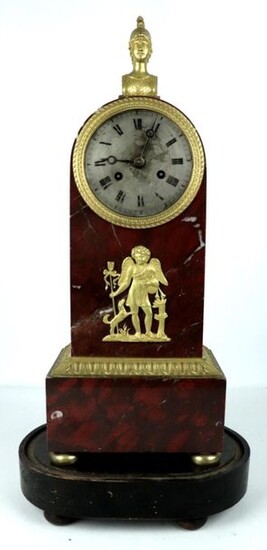Red Morello cherry marble and gilt bronze clock, with applied decoration of a love, surmounted by a bust of Hermes.