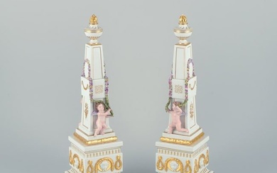 Royal Copenhagen Flora Danica, a pair of obelisks for table decoration. Putti surrounded by