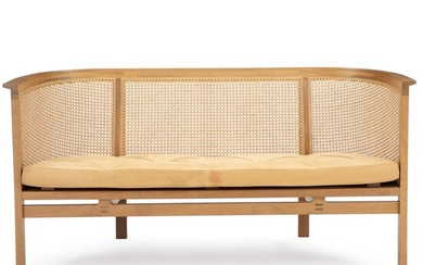 SOLD. Rud Thygesen, Johnny Sørensen: “Kongeserie”. Two seater sofa with mahogany frame. Sides and back stretched with woven cane. Upholstered with natural leather. – Bruun Rasmussen Auctioneers of Fine Art