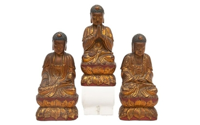 TRIAD OF RED AND GOLD LACQUERED WOODEN BUDDHAS...