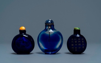 Three Chinese transparent blue glass snuff bottles, one...
