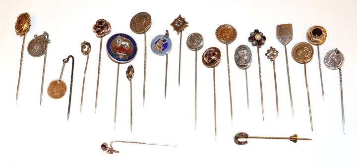 Twenty-Two Stick Pins, including a ruby diamond and pearl example,...