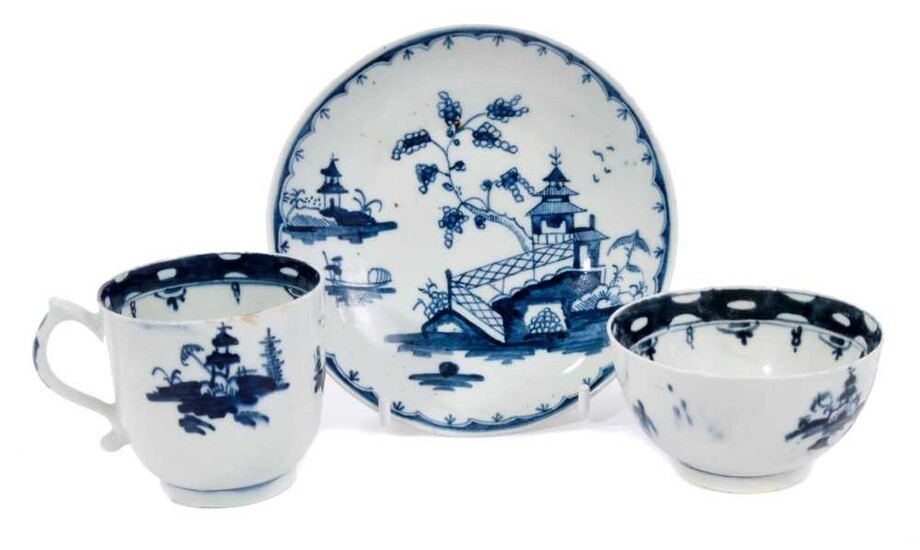 18th century Lowestoft blue and white porcelain tea trio, decorated with a chinoiserie pattern, the saucer with a variant border pattern