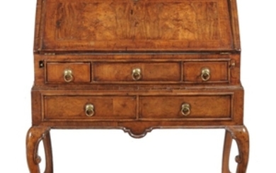 A Queen Anne or George I walnut and feather banded bureau