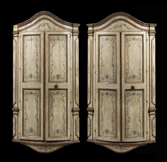 A pair of lacquered wooden hanging corner cabinets.