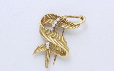 750-thousandths gold clip brooch, stylizing a leaf coiled...