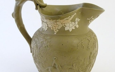 A 19thC jug with relief decoration depicting a hunting