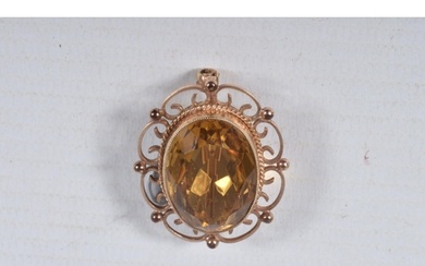 A 9CT GOLD CITRINE BROOCH, of an oval form, set with a large...