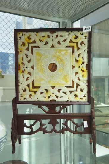 A CARVED JADE ORNAMENT ON ROSEWOOD STAND
