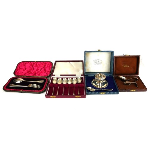 A COLLECTION OF CASED SILVER ITEMS To include an egg cup and...
