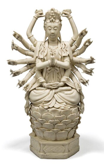 A Chinese Dehua porcelain figure of multi-armed Guanyin, 20th century, seated in dhyanasana on a lotus throne, 43cm high