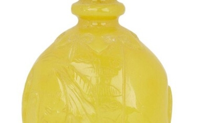 A Chinese Peking yellow glass elephant-form snuff bottle, mid-19th century, carved in the form of an elephant with a vessel on its back emerging from ruyi lappets, 7.8cm high, glass stopper