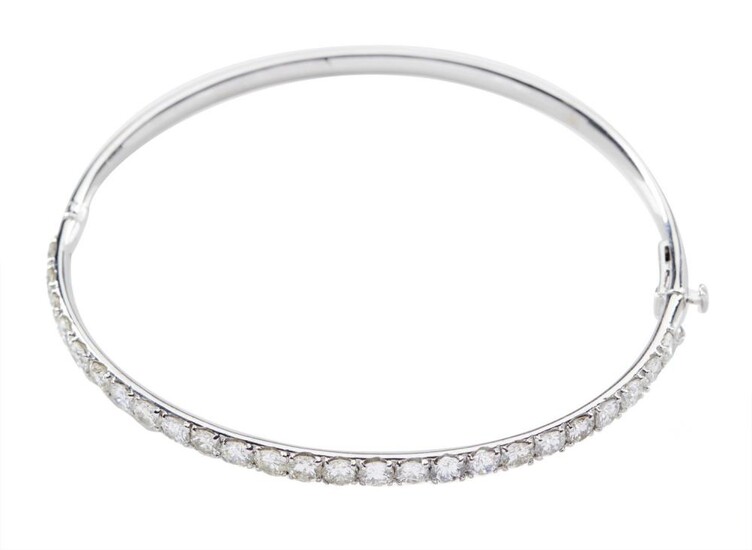 A DIAMOND BANGLE - The hinged bangle set with twenty five round brilliant cut diamonds totalling 4.25cts, in 18ct white gold, 12.6GMS