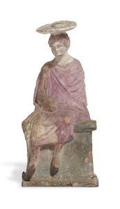 A GREEK TERRACOTTA SEATED YOUTH, HELLENISTIC PERIOD, CIRCA EARLY 3RD CENTURY B.C.