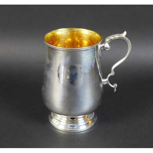A George V silver tankard, of baluster form with scroll hand...