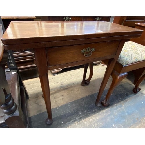 A Georgian mahogany foldover side table with a single drawer...