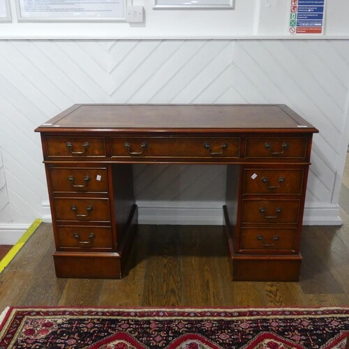A Georgian-style elm Pedestal Desk, the top with leather ins...