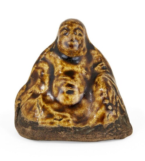 A Japanese glazed composite Budai netsuke, Meiji period, seated buddha with prayer beads in hand, hollow with cord holes to Budai's back, 6.5cm high