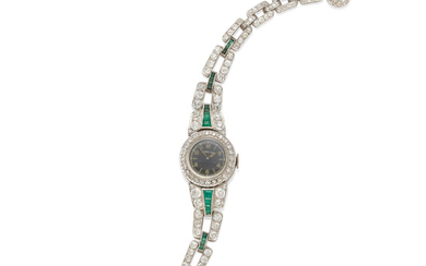 A Ladies Diamond, Emerald, and Platinum Bracelet Wristwatch