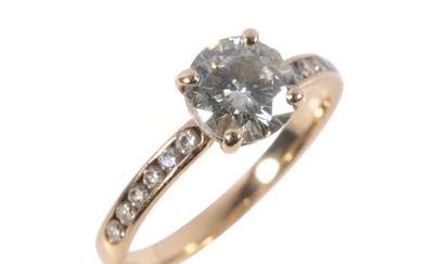 A MOISSANITE SOITAIRE RING claw-set on a 9ct yellow gold sha...