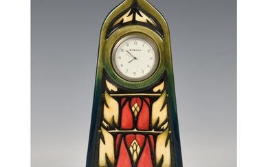 A Moorcroft mantel clock, in black glaze with red, cream and...
