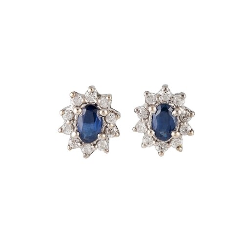 A PAIR OF SAPPHIRE AND DIAMOND CLUSTER EARRINGS, the oval sa...