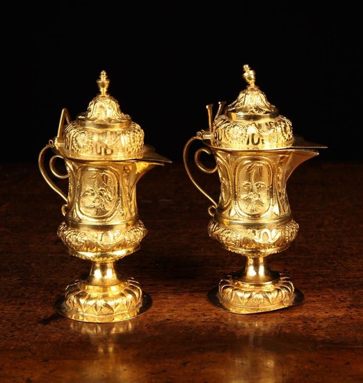 A Pair of Antique Italian Silver Gilt Aqua Vino Cruets embossed and chased with elaborate decoration