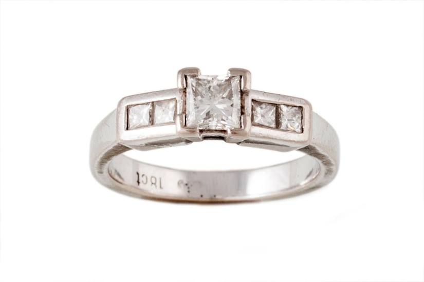 A SOLITAIRE DIAMOND RING, the principal diamond estimated to...