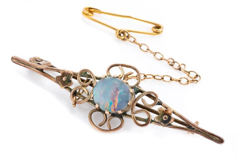 A VINTAGE 9CT GOLD OPAL BROOCH; centring an oval opal doublet to wire work and flower design (damaged), length 5cm, wt. 2.99g.
