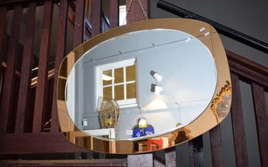 A VINTAGE GLASS WALL MIRROR