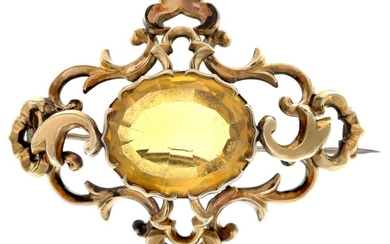 A Victorian Citrine Brooch The large oval cut citrine mounted in yellow metal with elaborate fo...