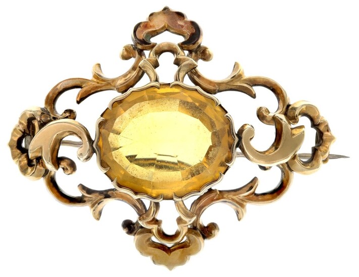 A Victorian Citrine Brooch The large oval cut citrine mounted in yellow metal with elaborate fo...