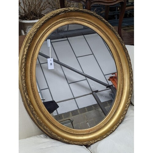 A Victorian oval giltwood and gesso wall mirror, width 80cm,...
