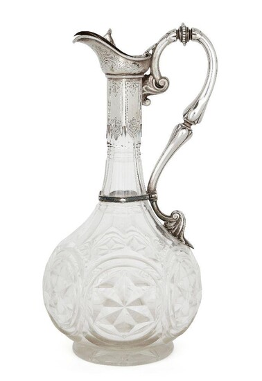 A Victorian silver mounted cut glass claret jug, Birmingham, 1870, Thomas Prime & Son, the globular star-cut glass body to a tapering panelled neck, the hinged cover designed with foliate thumbpiece to a stylised foliate scroll handle, 29cm high