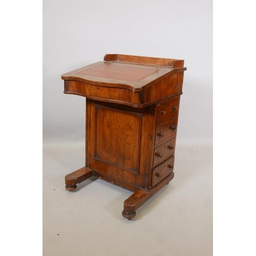 A Victorian walnut davenport with four drawers and four dumm...