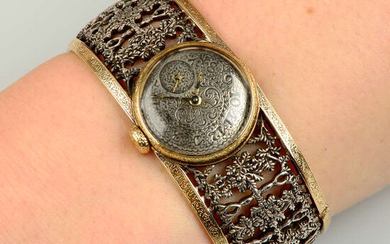 A bi-colour watch cuff bangle, by Buccellati.