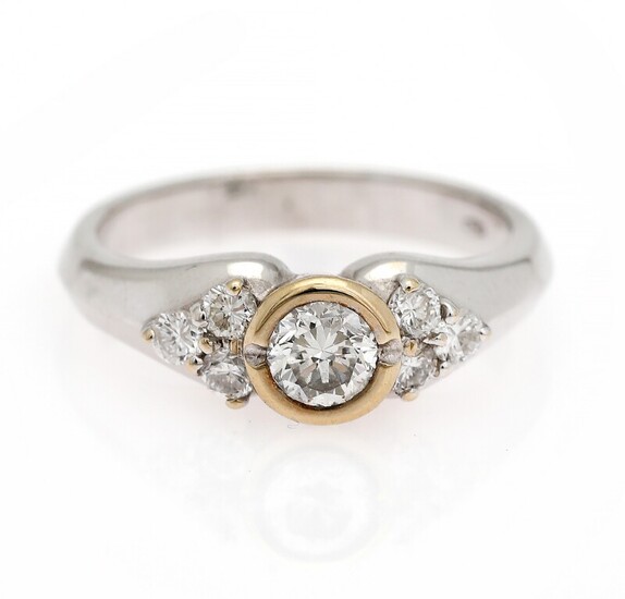 NOT SOLD. A diamond ring set with a diamond weighing app. 0.34 ct. flanked by...