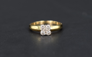 A four stone diamond square set ring having a central diamond chip,total approx 0.50ct, all in a