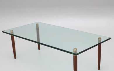 A glass top coffee table, brass shod legs, stained beech, Örebro glasindustri AB, later half of the 20th century.