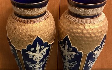 A large pair of Royal Doulton vases with gilt decoration.