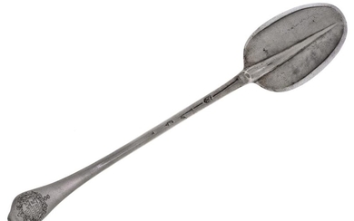 A late 17th/early 18th century silver dog-nose basting spoon, London, c.1700, Thomas Allen, with a rat-tail bowl, the reverse of the terminal engraved with full coat of arms, 33.9cm long, approx. weight 7.7oz Provenance: The estate of the late...