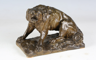A late 19th century Continental green patinated cast bronze model of a barking dog, raised on a natu