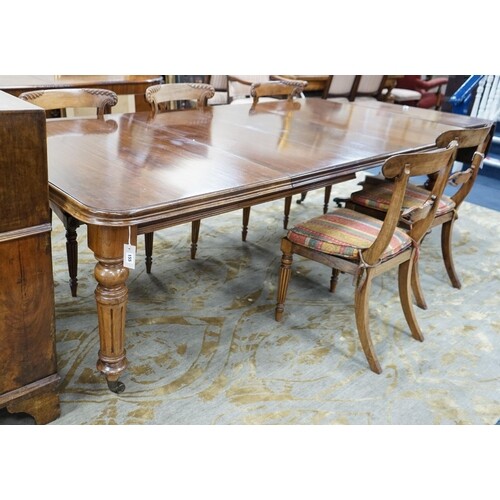 A late Victorian walnut wind-action dining table with two ex...