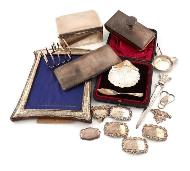 A mixed lot of silver items, comprising: a cased butter dish and spoon, of shell form, Sheffield 1894, a modern money clip, by Asprey, London 1968, engraved with Prince of Wales feathers, a paper knife, with a Prince of Wales feathers terminal, a...