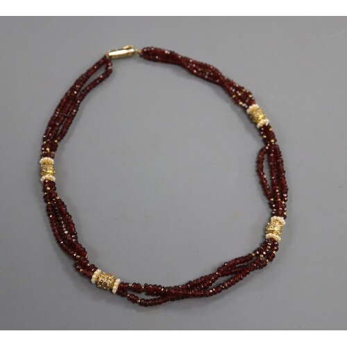 A modern gilt metal mounted and rough cut garnet bead triple...
