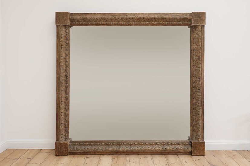A monumental carved pine-framed wall mirror
